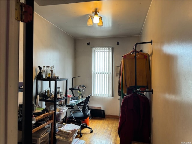 home office with light hardwood / wood-style floors