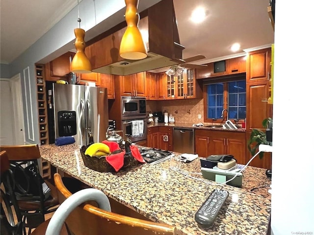 kitchen featuring sink, stainless steel appliances, light stone counters, decorative light fixtures, and decorative backsplash