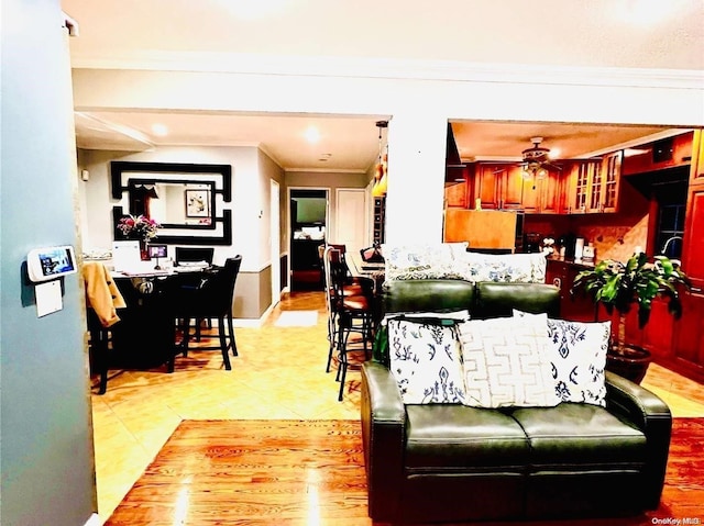 living room featuring ceiling fan and ornamental molding