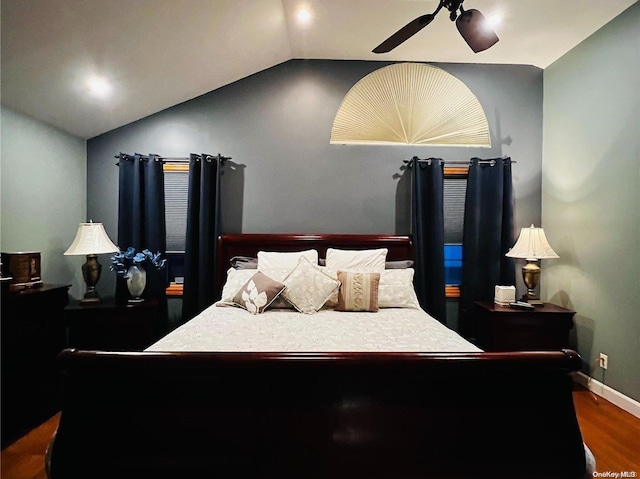 bedroom with dark hardwood / wood-style floors, ceiling fan, and lofted ceiling