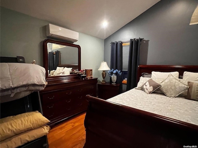 bedroom with wood-type flooring, vaulted ceiling, and an AC wall unit