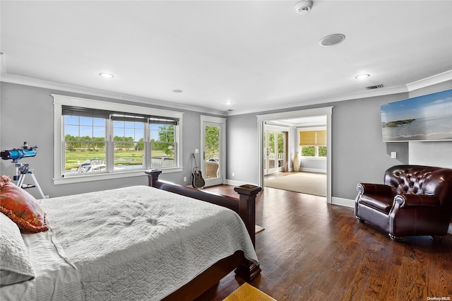 bedroom featuring ornamental molding, dark wood-type flooring, and multiple windows