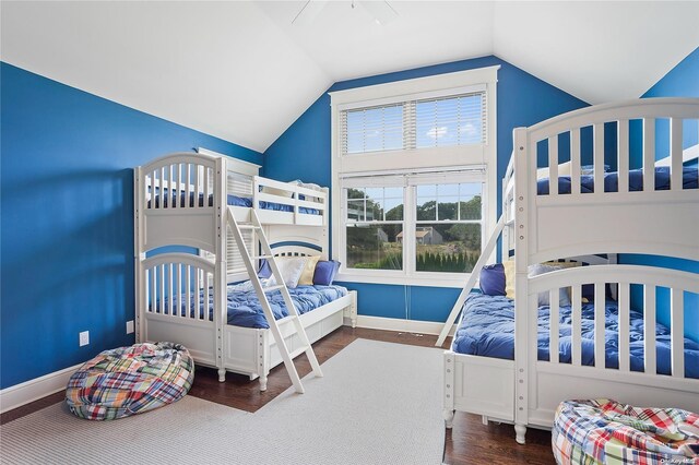 bedroom with hardwood / wood-style floors and lofted ceiling