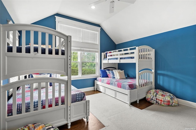 bedroom with ceiling fan, wood-type flooring, and vaulted ceiling