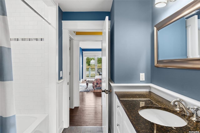 bathroom with vanity, hardwood / wood-style flooring, and shower / tub combo with curtain