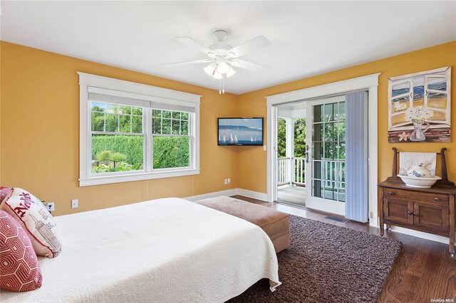 bedroom with ceiling fan, dark hardwood / wood-style flooring, access to outside, and multiple windows