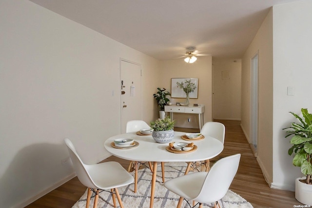 dining room featuring ceiling fan and light wood-type flooring