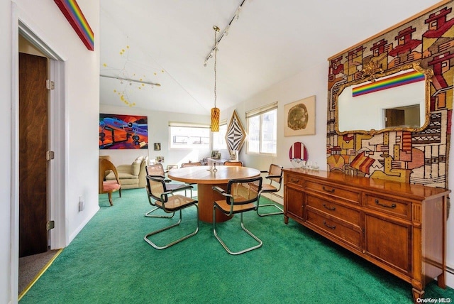 dining space featuring track lighting and dark colored carpet