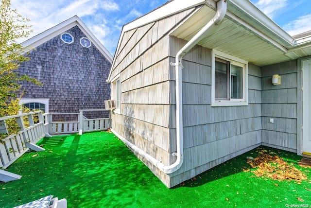 view of property exterior with a lawn and cooling unit