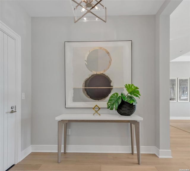 details featuring hardwood / wood-style flooring and an inviting chandelier