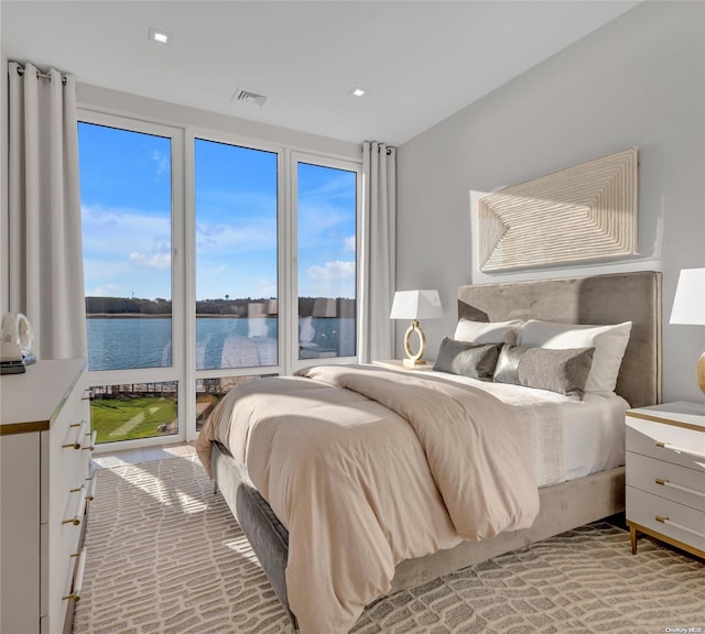 bedroom featuring a water view