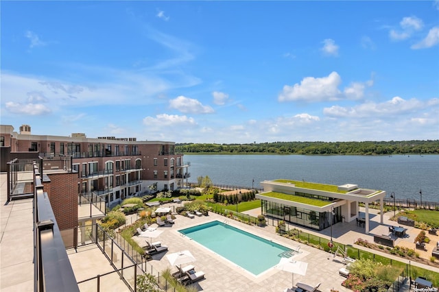 view of pool with a patio area and a water view