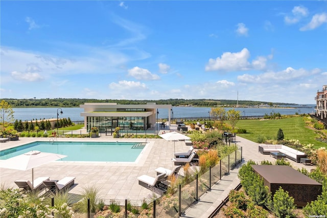 view of pool featuring a patio area and a water view