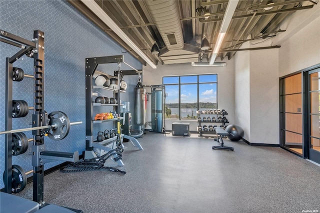 workout area with a high ceiling