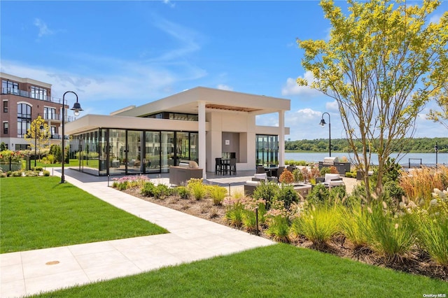 view of community featuring a yard and a water view