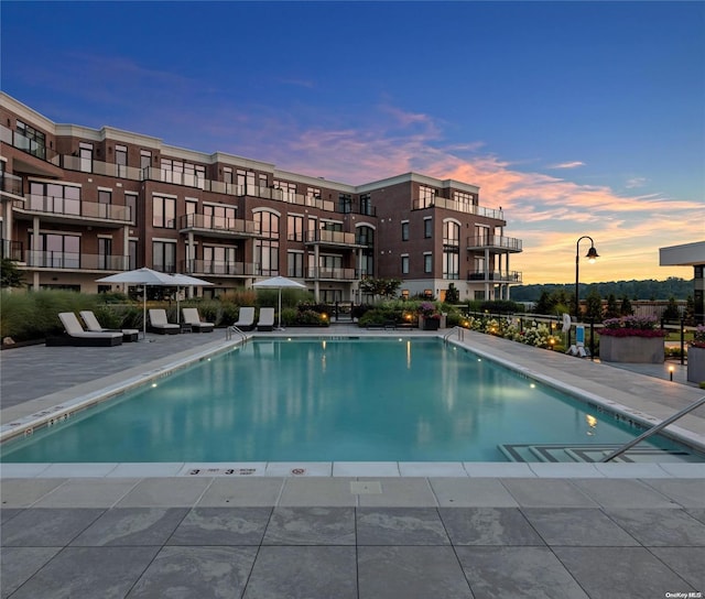 pool at dusk with a patio