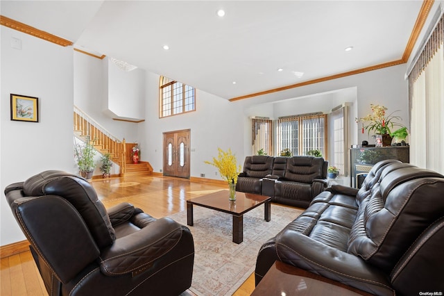 living room with light hardwood / wood-style flooring, a healthy amount of sunlight, and ornamental molding