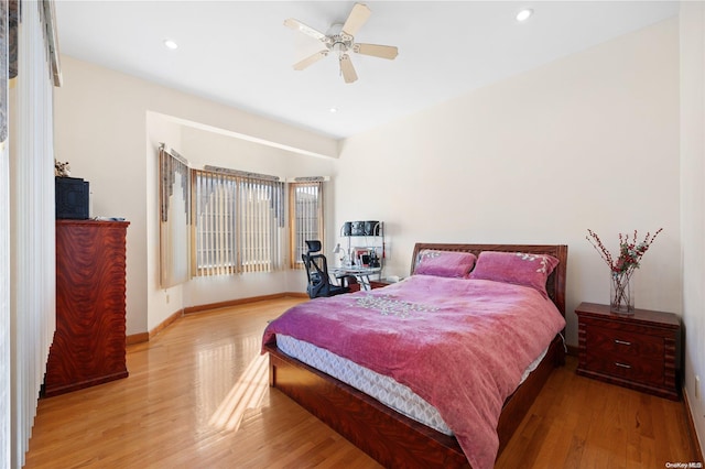 bedroom with light hardwood / wood-style flooring and ceiling fan