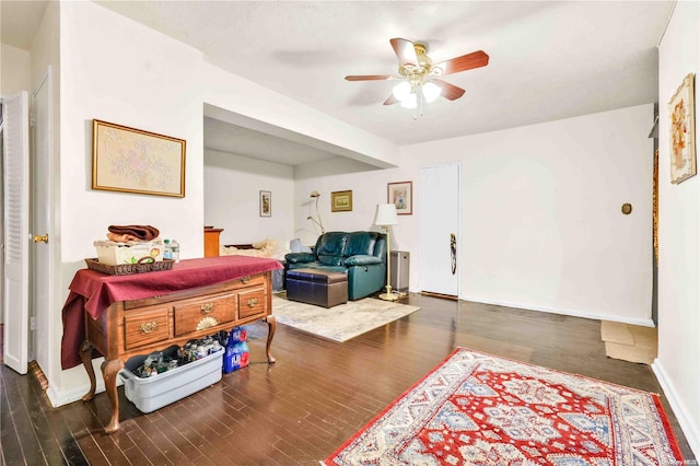 interior space with dark hardwood / wood-style flooring and ceiling fan