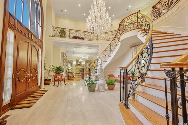 foyer entrance featuring a chandelier, a high ceiling, and light tile patterned floors