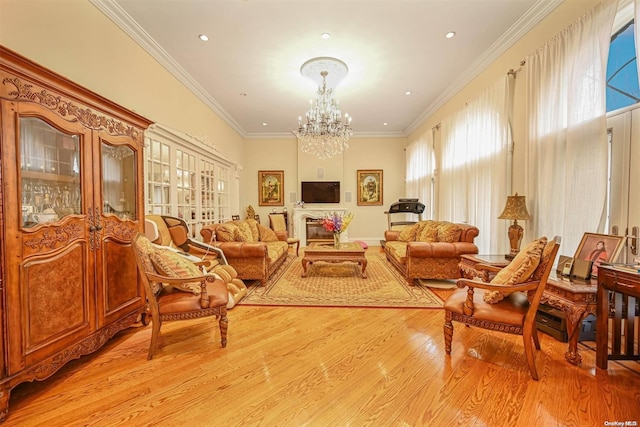 sitting room featuring a chandelier, light hardwood / wood-style floors, and ornamental molding