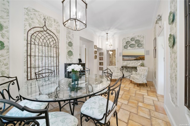 dining space featuring a chandelier and ornamental molding