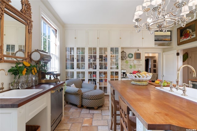 dining area with sink and a chandelier