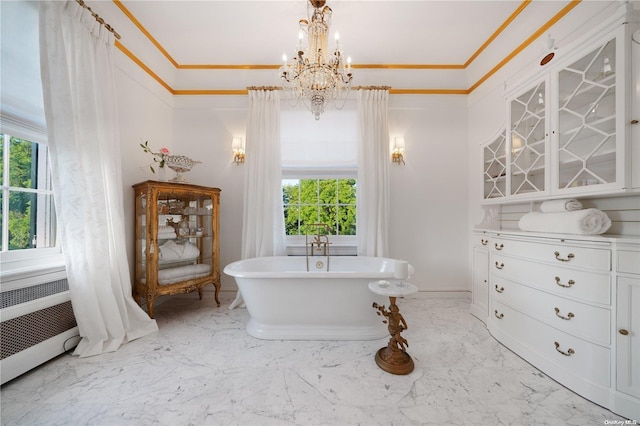 bathroom with a bathtub, ornamental molding, radiator, and an inviting chandelier