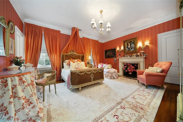 bedroom with hardwood / wood-style floors, a notable chandelier, and ornamental molding