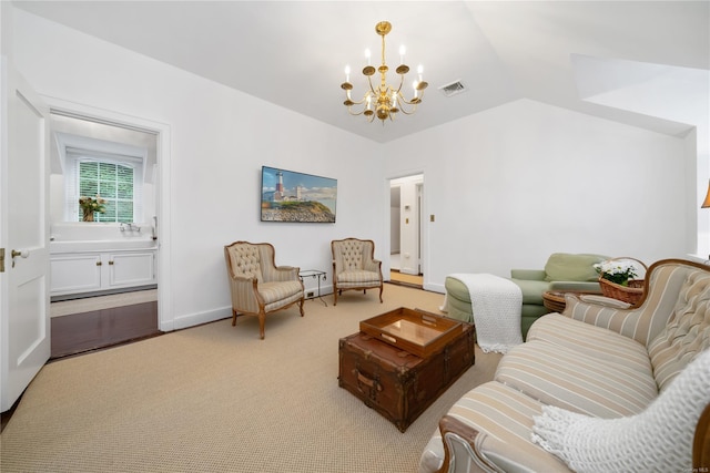 sitting room featuring wood-type flooring, lofted ceiling, and an inviting chandelier