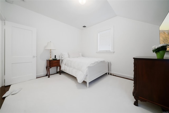 carpeted bedroom featuring vaulted ceiling