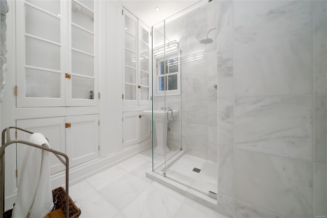 bathroom featuring a shower with shower door