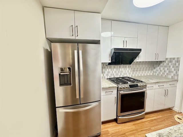 kitchen featuring decorative backsplash, white cabinetry, light wood-type flooring, and stainless steel appliances