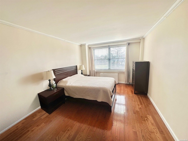 bedroom featuring hardwood / wood-style flooring and ornamental molding