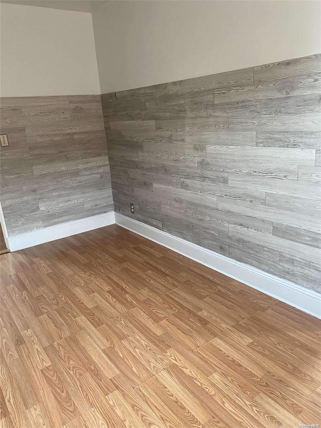 unfurnished room featuring light wood finished floors and baseboards