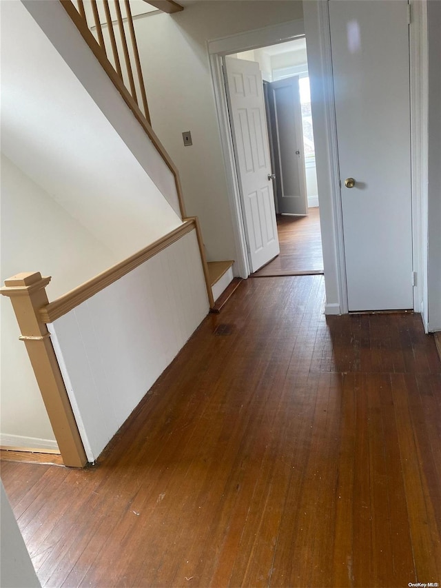 hallway featuring dark wood-style floors and stairway