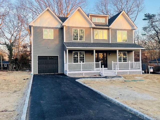 view of front of property featuring a porch and a garage