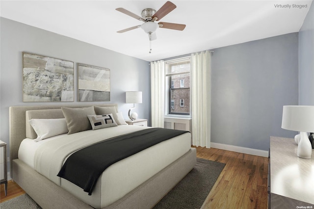 bedroom featuring hardwood / wood-style floors and ceiling fan