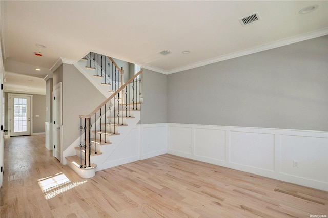 empty room featuring light hardwood / wood-style floors and ornamental molding