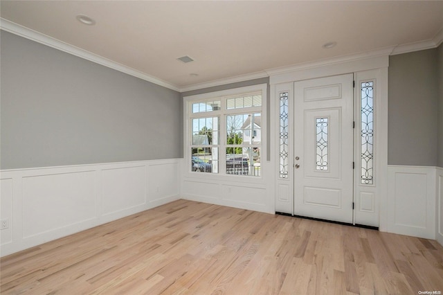 foyer entrance featuring ornamental molding and light hardwood / wood-style flooring