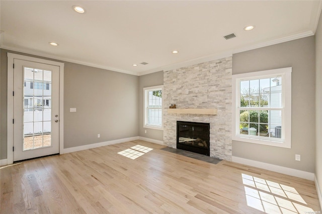 unfurnished living room with a fireplace, light hardwood / wood-style flooring, and ornamental molding