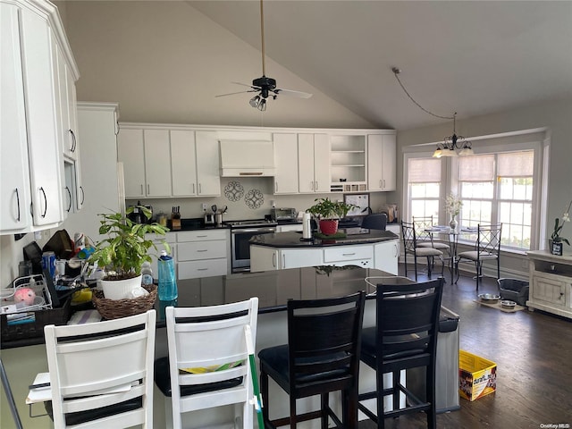 kitchen featuring dark wood-type flooring, electric stove, white cabinets, ceiling fan with notable chandelier, and custom exhaust hood