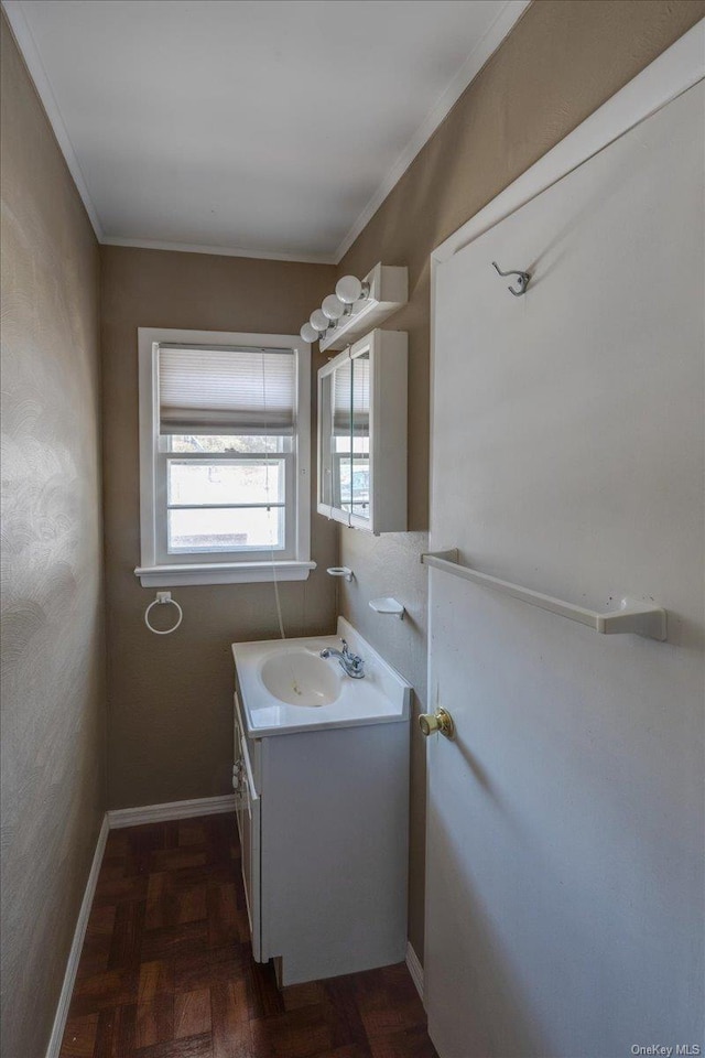 bathroom with crown molding, parquet flooring, and vanity