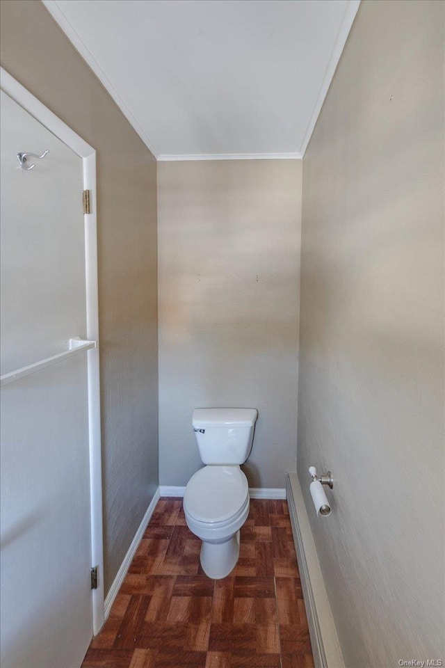 bathroom featuring parquet floors, toilet, and crown molding