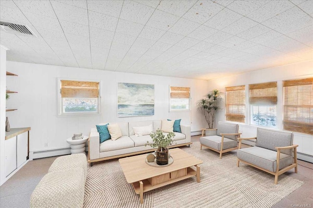 living room featuring carpet and a baseboard heating unit