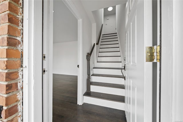 stairway with hardwood / wood-style floors