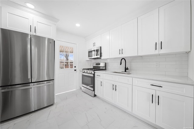 kitchen featuring white cabinets, backsplash, sink, and stainless steel appliances