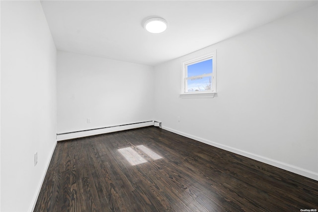 spare room featuring hardwood / wood-style floors and a baseboard radiator