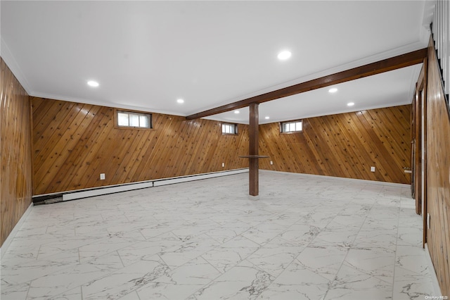 basement featuring crown molding, wooden walls, and a baseboard radiator