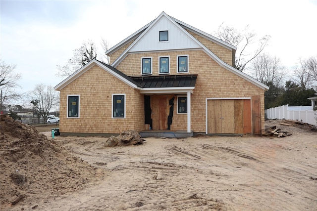 rear view of property with a garage